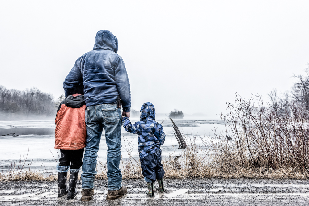 Family at mist covered lake